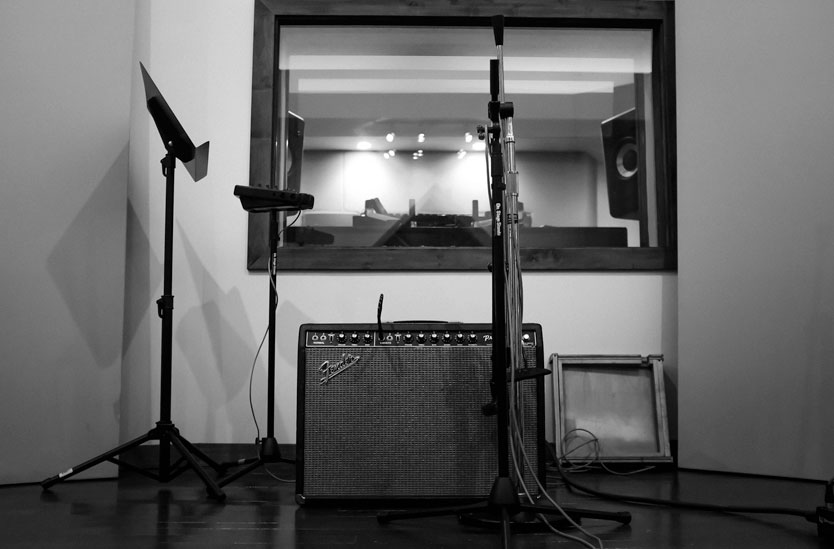 Fender Princeton amplifier with music stand and microphone in a recording studio booth